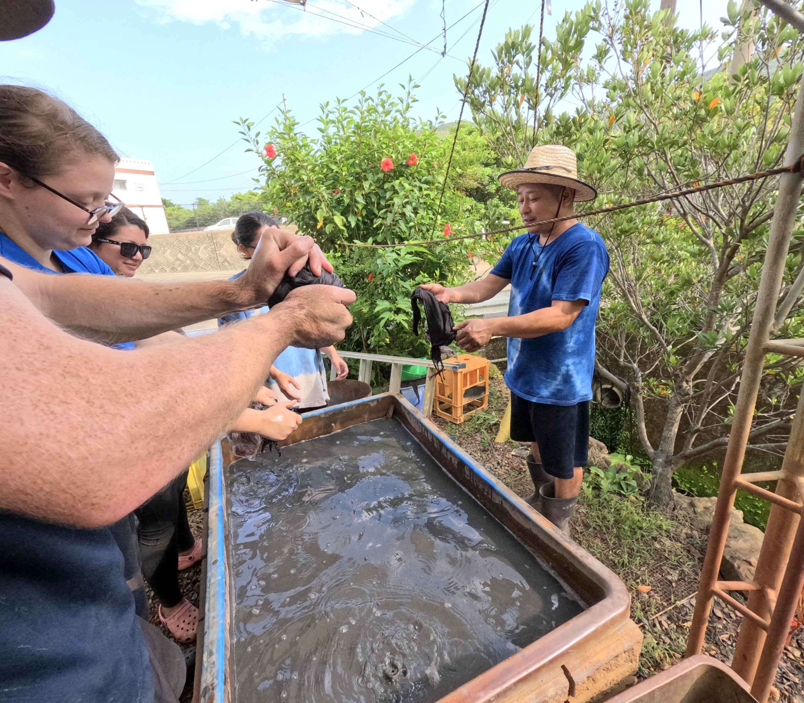 An artisan explaining the mud of Amami Oshima.