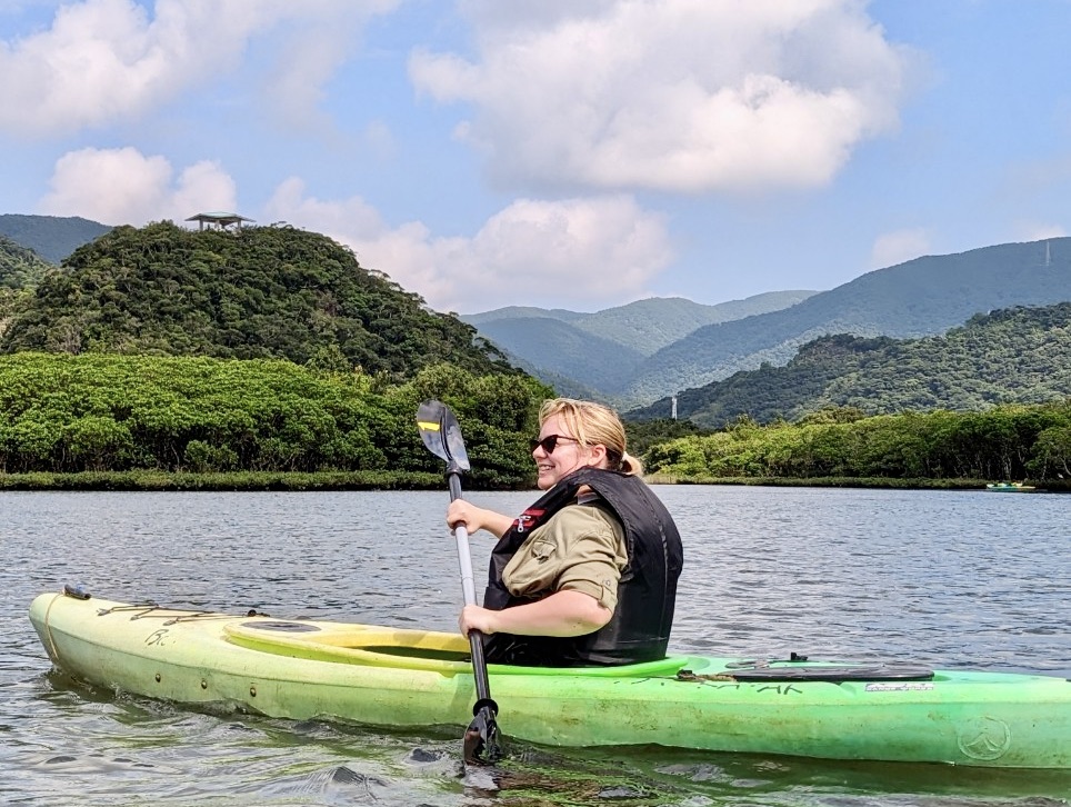 A woman is enjoying kayaking in the mangrove forest.