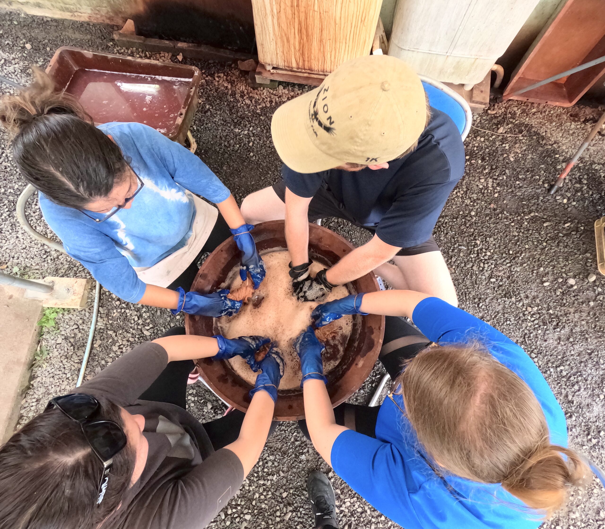 Participants engaged in natural dyeing using plants boiled water.