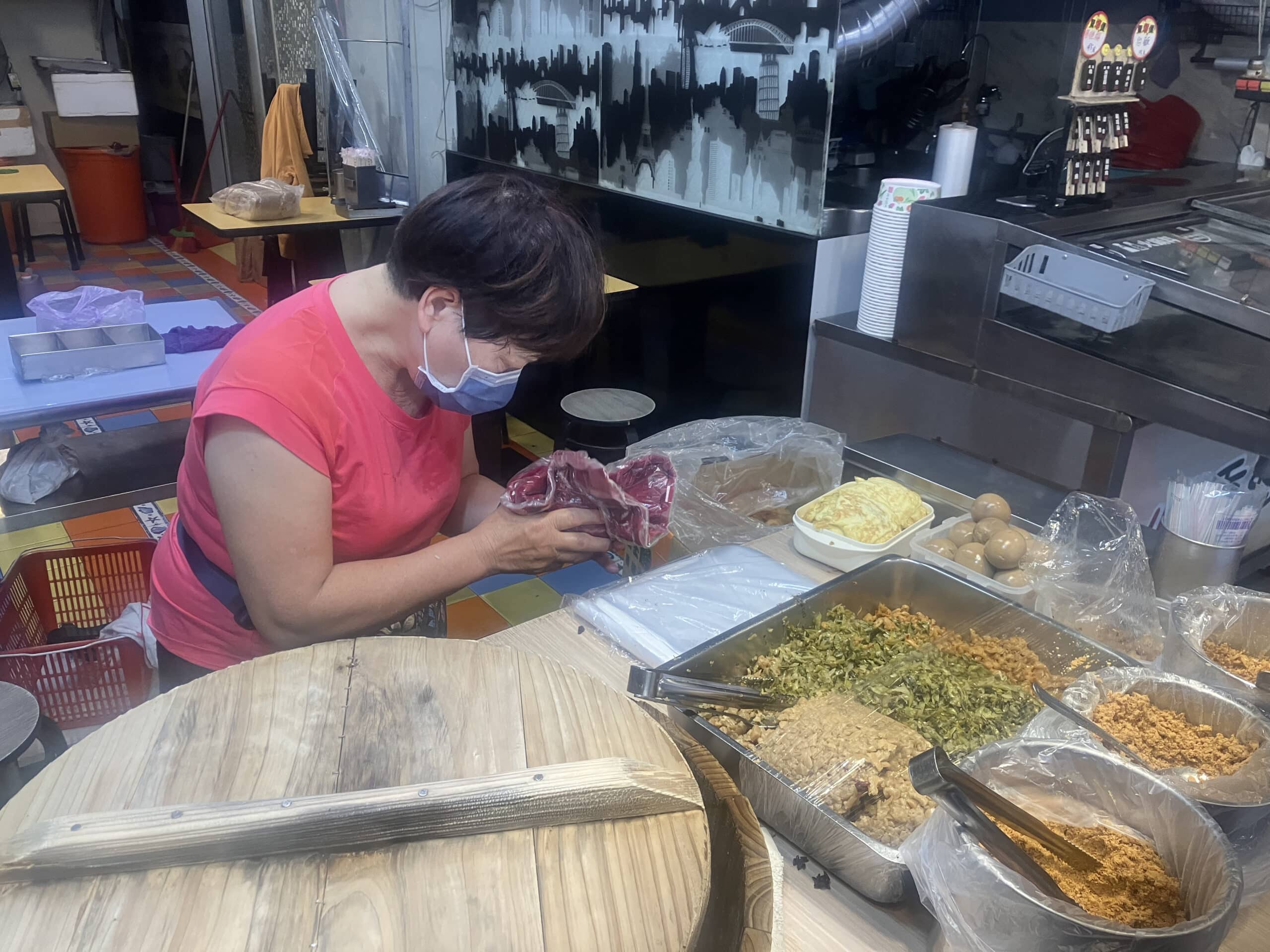 Woman selling rice balls at a food stall in Taipei.
