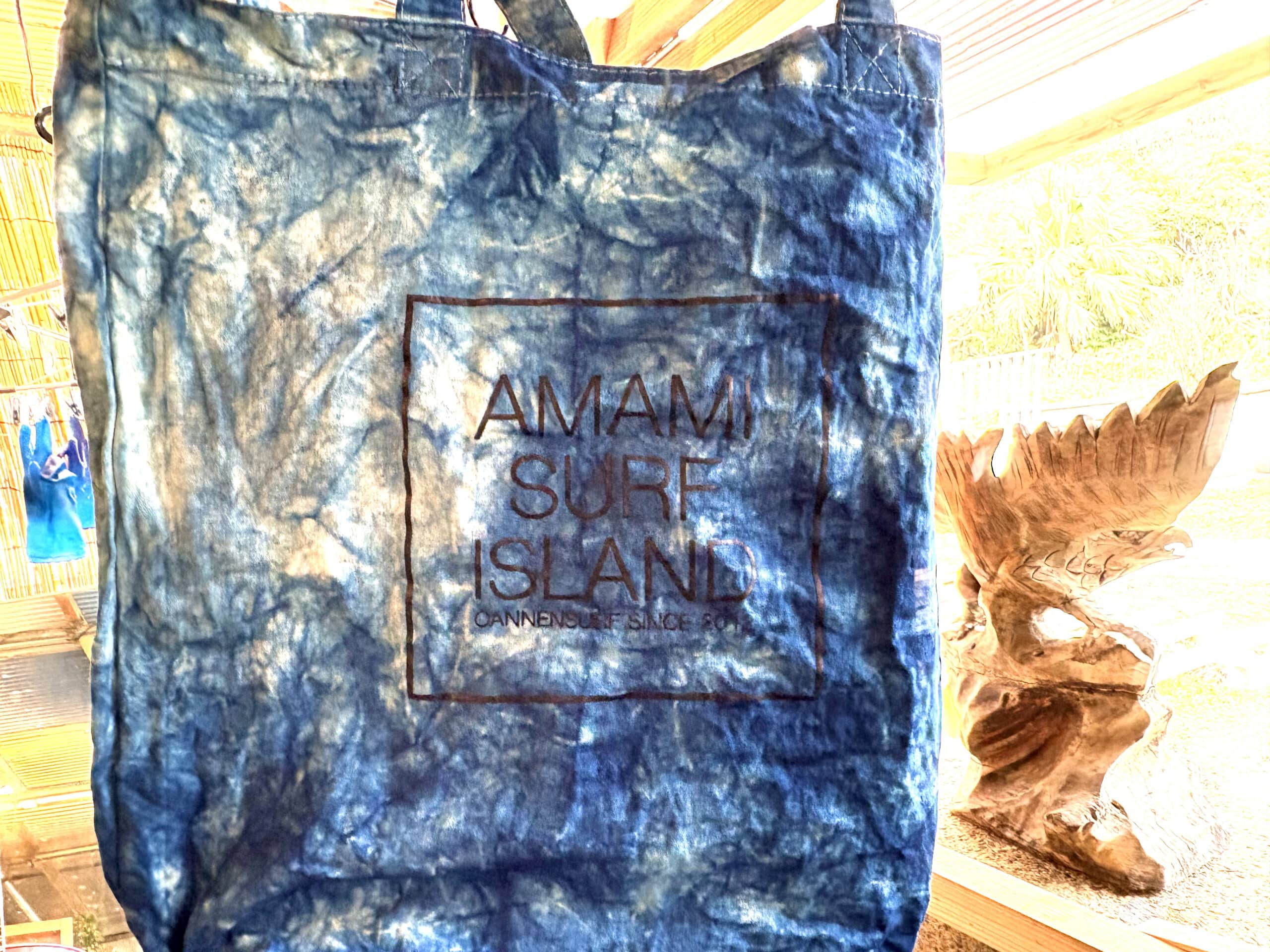Indigo-dyed tote bag with 'Amami Surf Island' logo, handcrafted on Amami Oshima