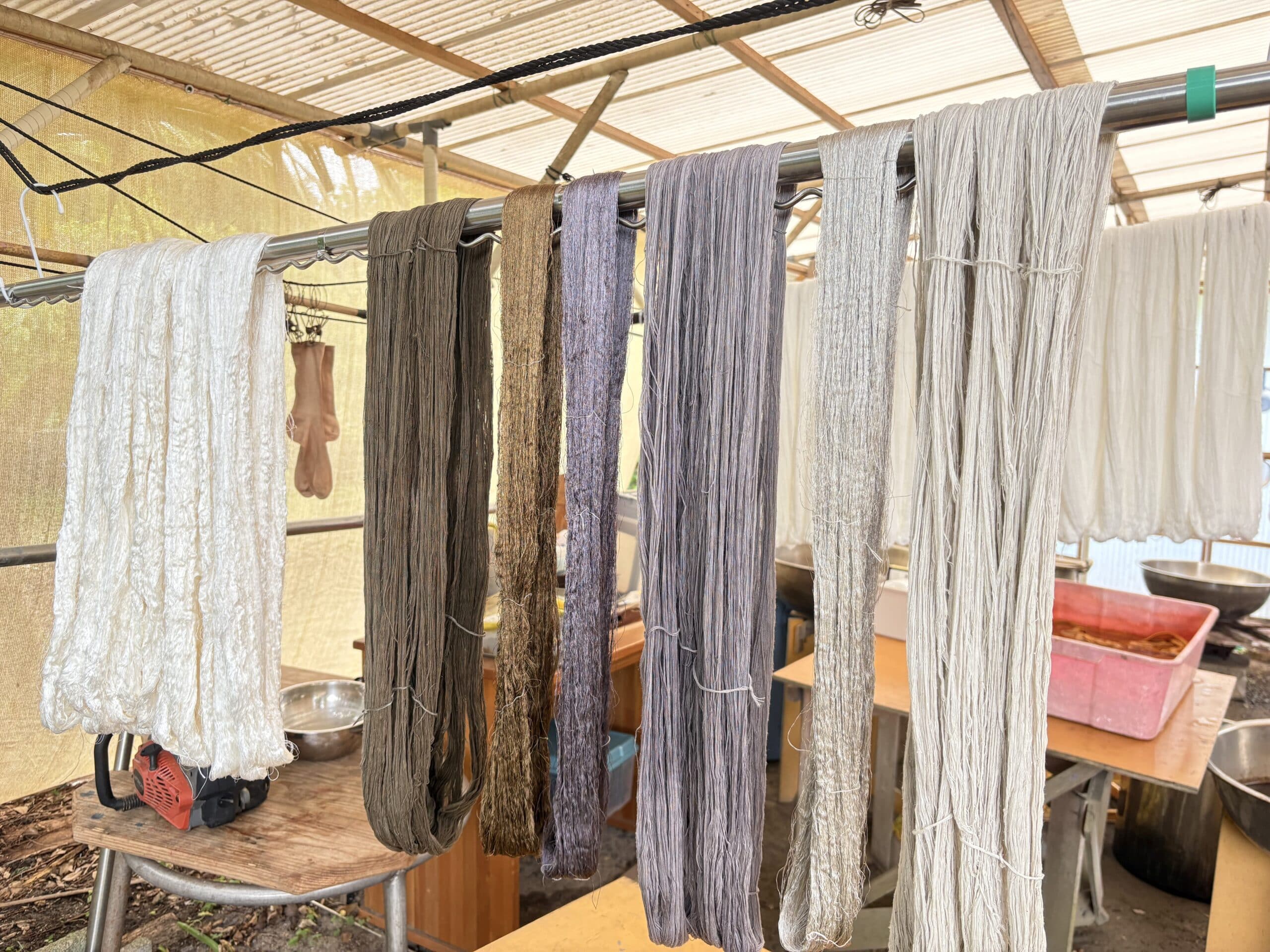 Naturally dyed threads hanging to dry at a traditional dyeing workshop on Amami Oshima