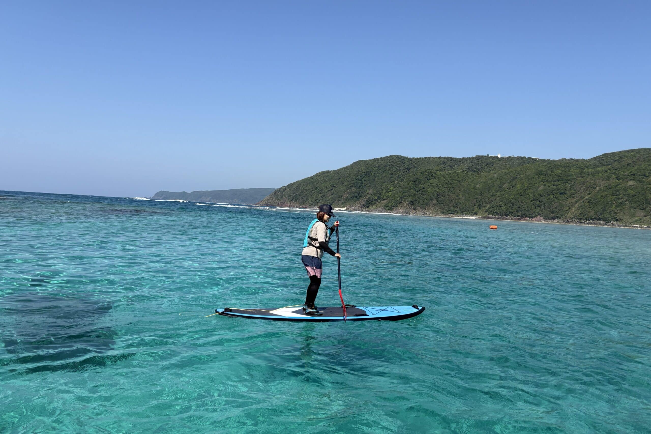Stand-up paddleboarding on crystal-clear waters off the coast of Amami Island